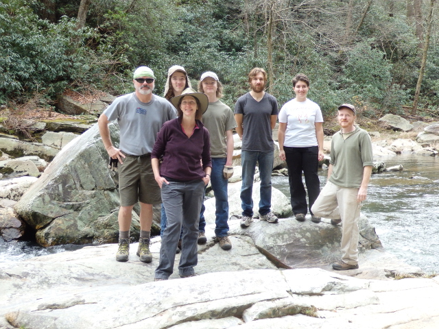 The crew pauses on the riverbank before starting work.